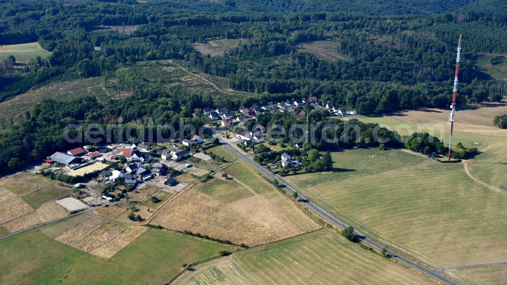 Aerial image Ginsterhahn - Agricultural land and field boundaries surround the settlement area of the village in Ginsterhahn in the state Rhineland-Palatinate, Germany