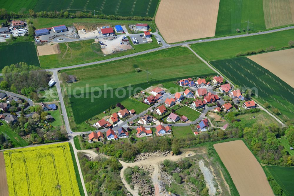 Gnodstadt from above - Agricultural land and field boundaries surround the settlement area of the village in Gnodstadt in the state Bavaria, Germany