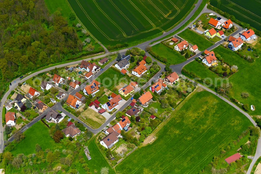 Aerial image Gnötzheim - Agricultural land and field boundaries surround the settlement area of the village in Gnötzheim in the state Bavaria, Germany