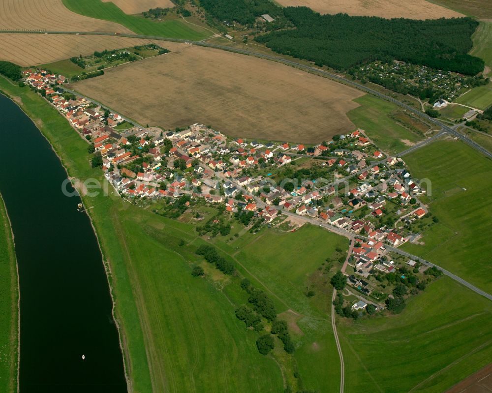 Gohlis from the bird's eye view: Agricultural land and field boundaries surround the settlement area of the village in Gohlis in the state Saxony, Germany