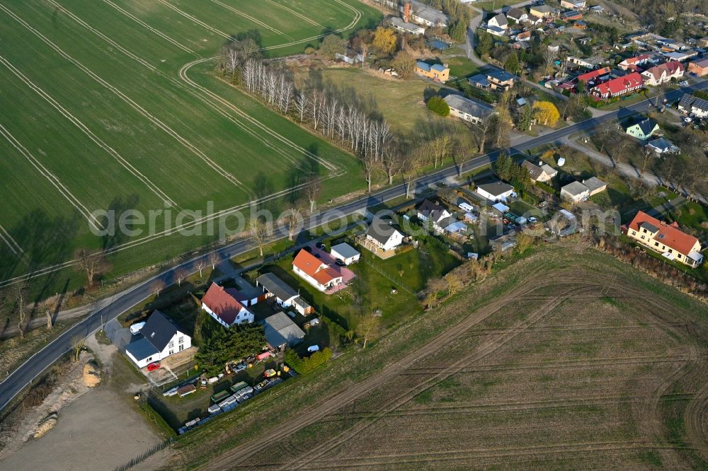 Gollmitz from above - Agricultural land and field boundaries surround the settlement area of the village in Gollmitz in the state Brandenburg, Germany