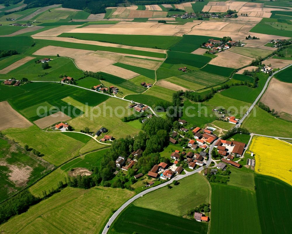 Gopping from above - Agricultural land and field boundaries surround the settlement area of the village in Gopping in the state Bavaria, Germany