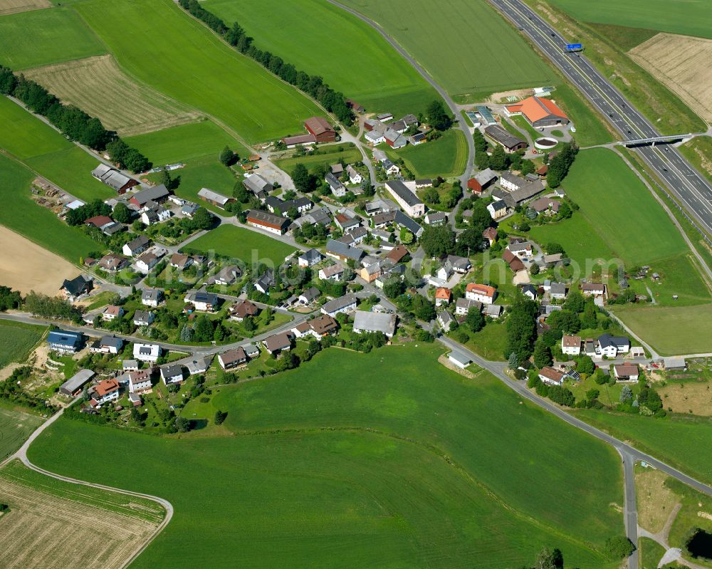 Gottersdorf from above - Agricultural land and field boundaries surround the settlement area of the village in Gottersdorf in the state Bavaria, Germany