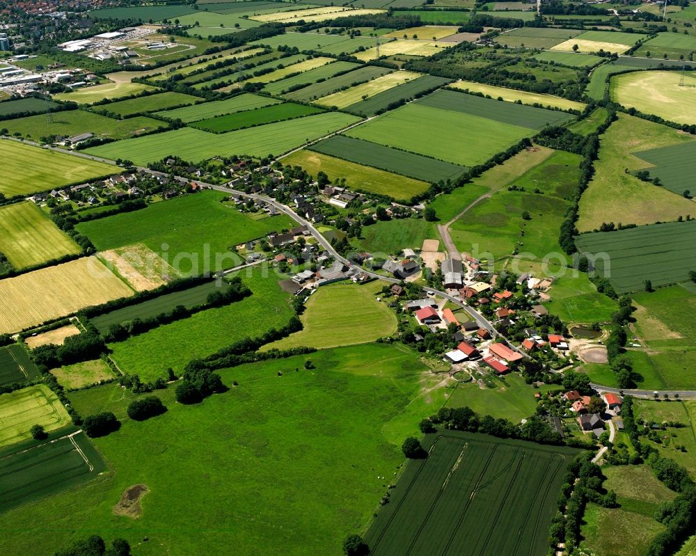 Grabau from the bird's eye view: Agricultural land and field boundaries surround the settlement area of the village in Grabau in the state Schleswig-Holstein, Germany