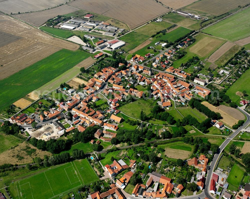 Grabe from above - Agricultural land and field boundaries surround the settlement area of the village in Grabe in the state Thuringia, Germany