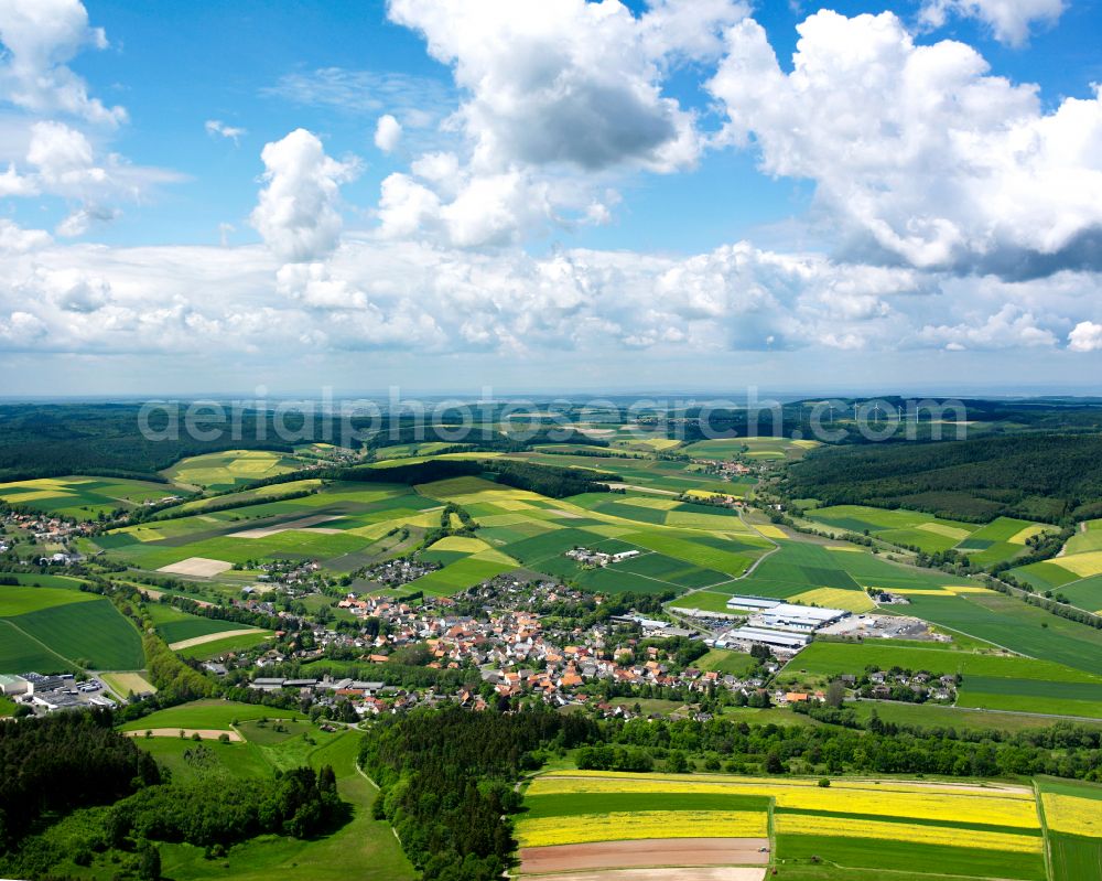 Aerial image Grebenau - Agricultural land and field boundaries surround the settlement area of the village in Grebenau in the state Hesse, Germany