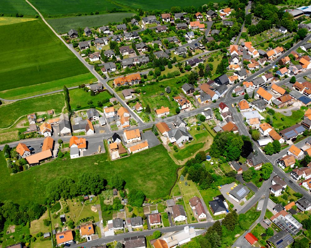 Aerial image Grebenau - Agricultural land and field boundaries surround the settlement area of the village in Grebenau in the state Hesse, Germany