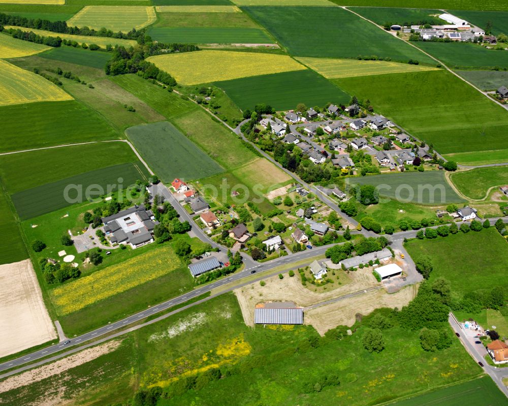 Aerial photograph Grebenau - Agricultural land and field boundaries surround the settlement area of the village in Grebenau in the state Hesse, Germany