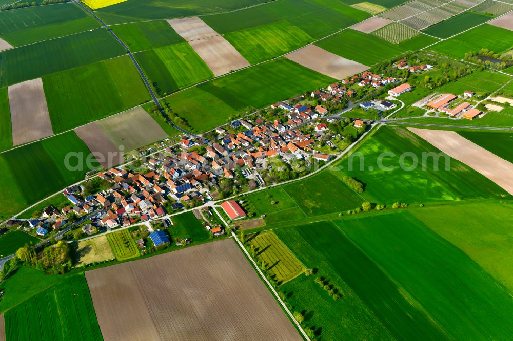 Greuth from above - Agricultural land and field boundaries surround the settlement area of the village in Greuth in the state Bavaria, Germany