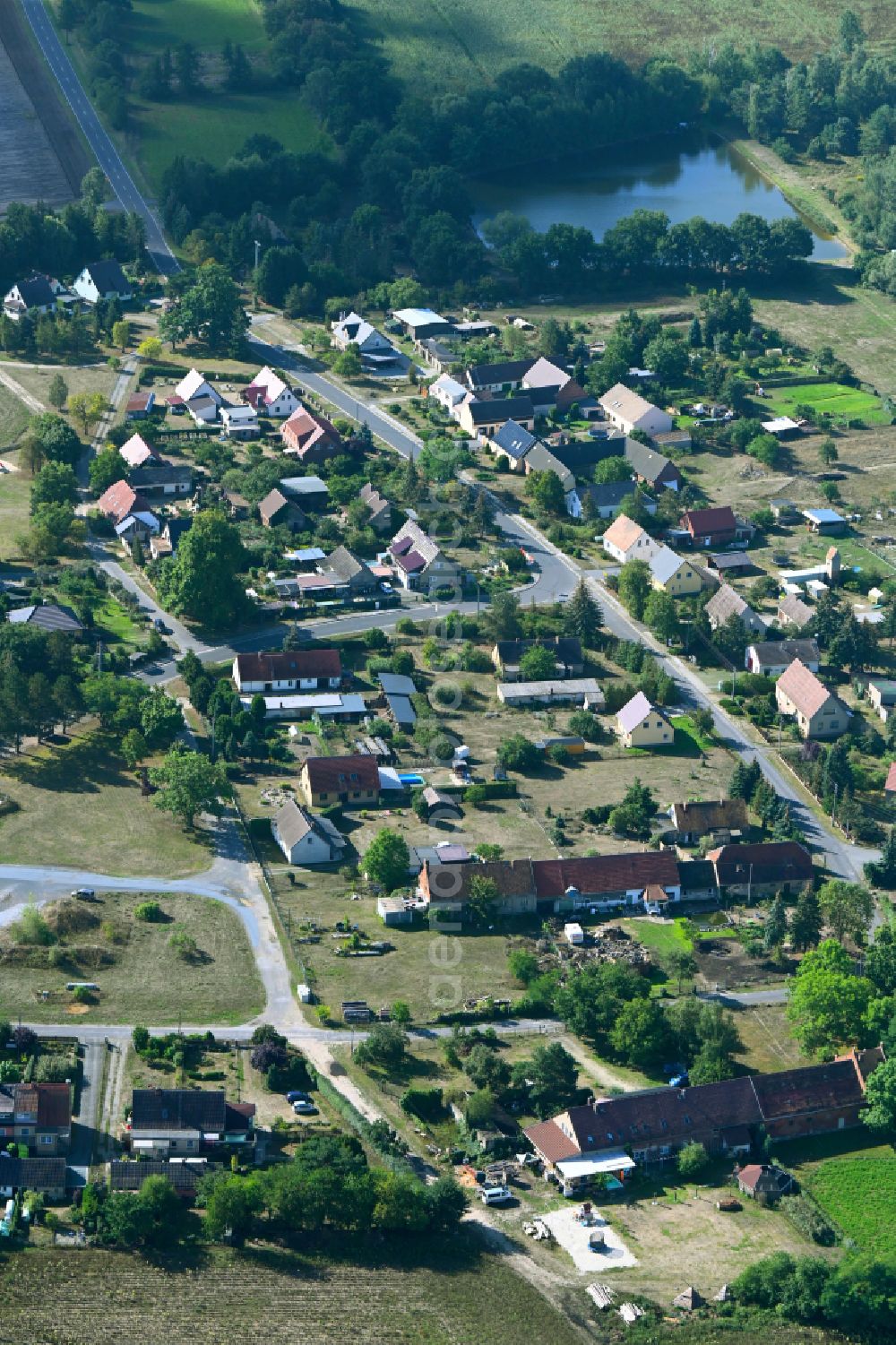 Aerial image Groß Jehser - Agricultural land and field boundaries surround the settlement area of the village on street Schmiedeweg in Gross Jehser in the state Brandenburg, Germany