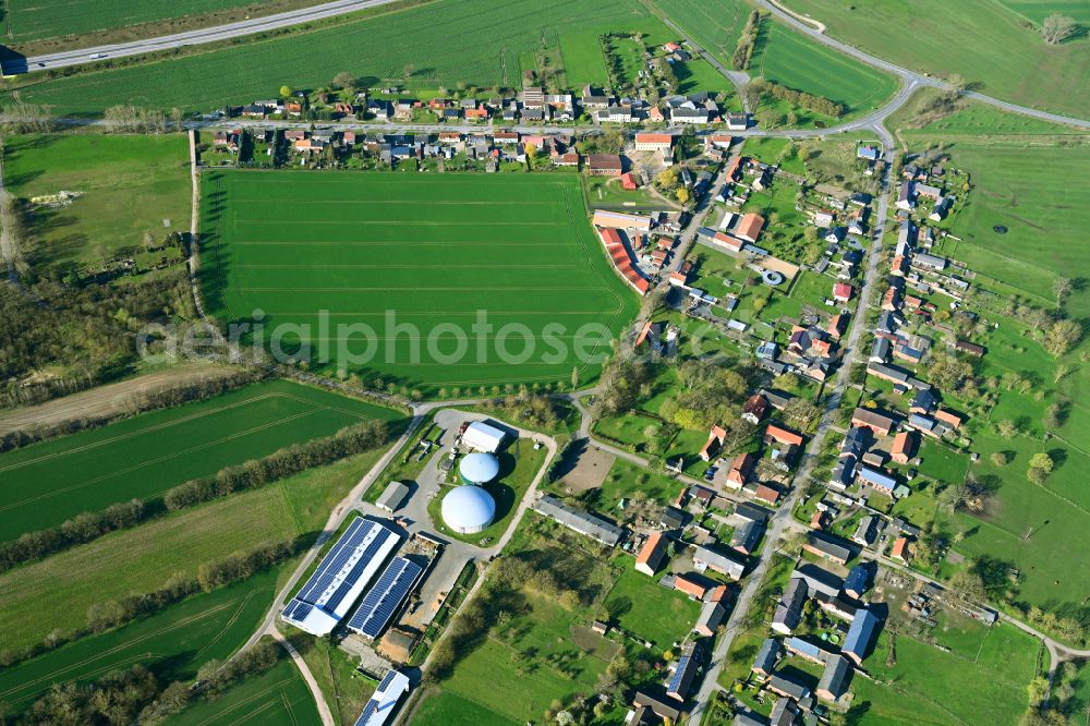 Aerial image Groß Warnow - Agricultural land and field boundaries surround the settlement area of the village on street Warnower Strasse in Gross Warnow in the state Brandenburg, Germany