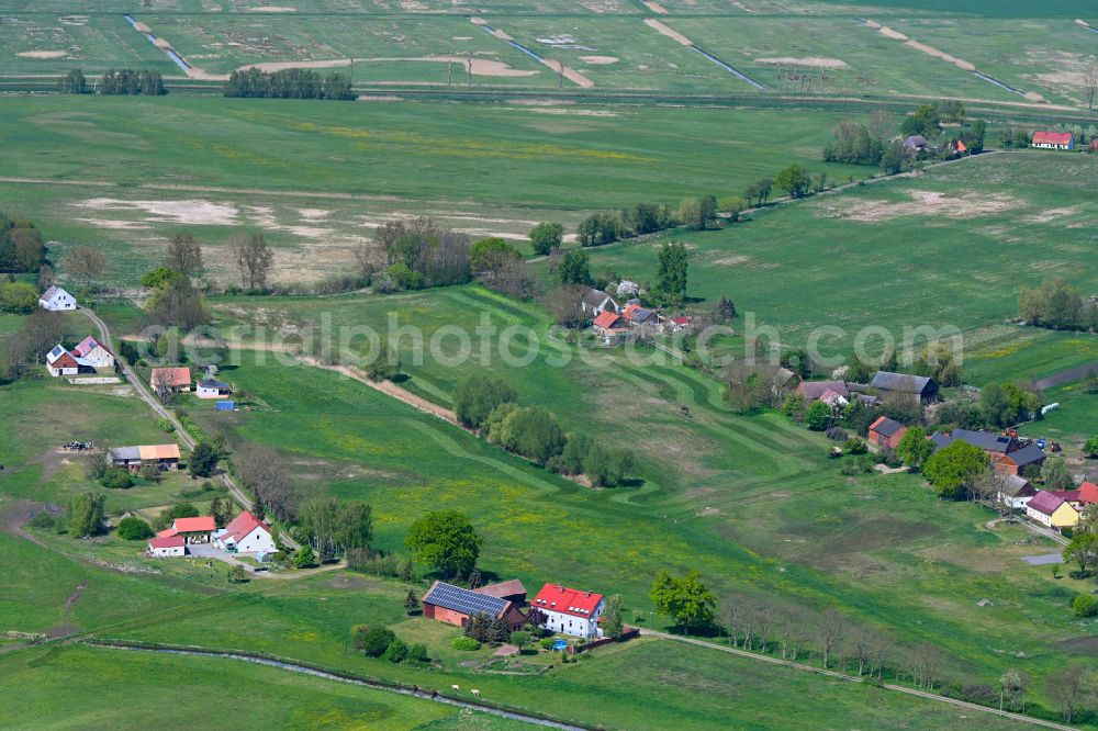 Großderschau from above - Agricultural land and field boundaries surround the settlement area of the village in Grossderschau in the state Brandenburg, Germany