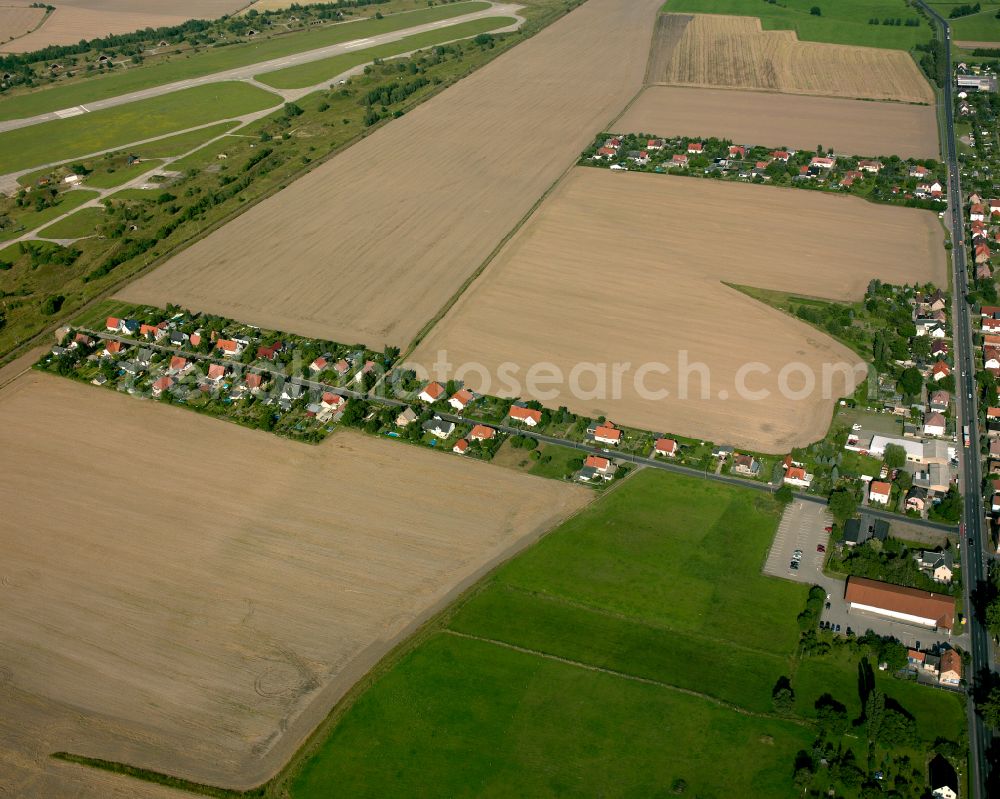 Großenhain from above - Agricultural land and field boundaries surround the settlement area of the village in Großenhain in the state Saxony, Germany