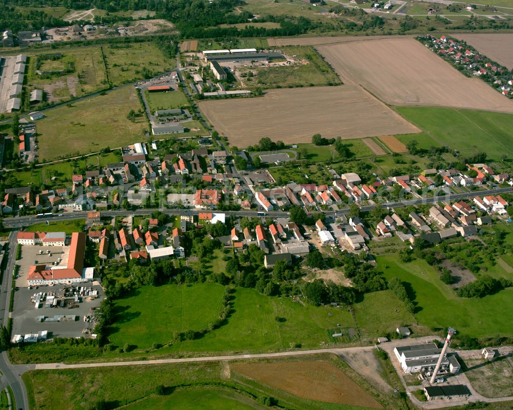 Großenhain from the bird's eye view: Agricultural land and field boundaries surround the settlement area of the village in Großenhain in the state Saxony, Germany