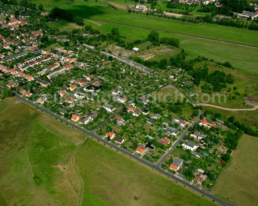 Großenhain from above - Agricultural land and field boundaries surround the settlement area of the village in Großenhain in the state Saxony, Germany