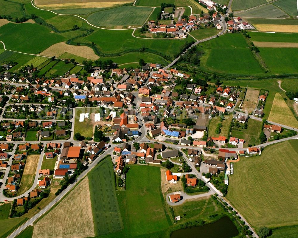 Großenried from above - Agricultural land and field boundaries surround the settlement area of the village in Großenried in the state Bavaria, Germany