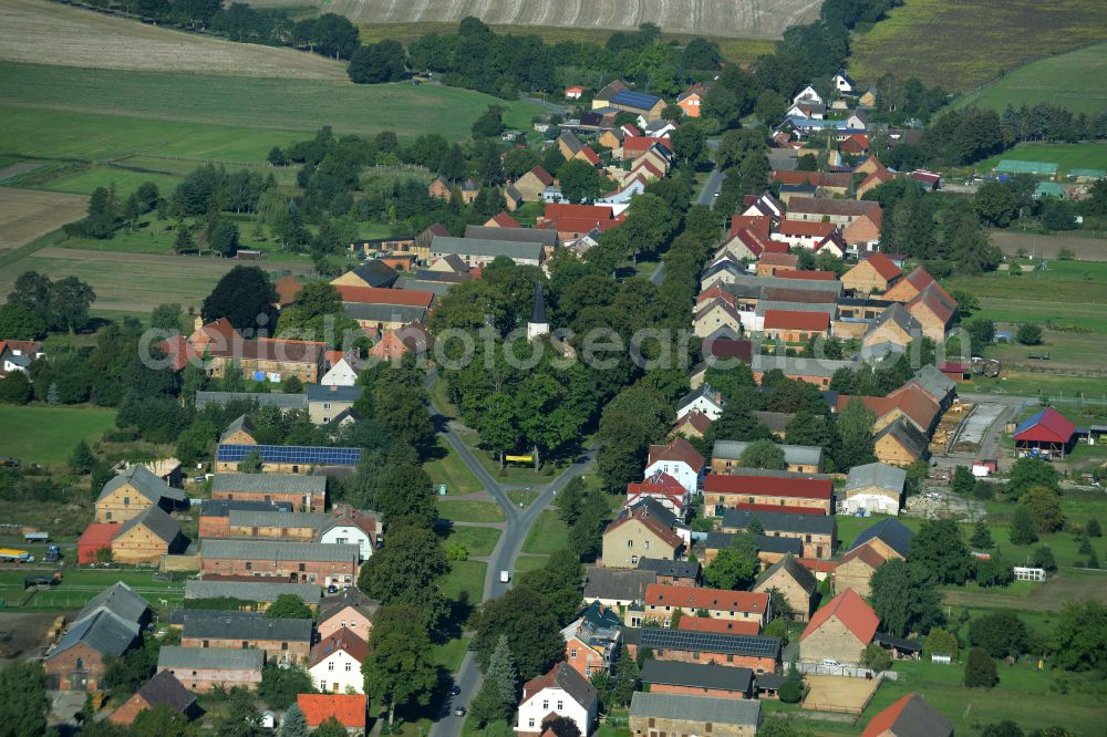 Aerial image Großmutz - Agricultural land and field boundaries surround the settlement area of the village on street Grossmutzer Dorfstrasse in Grossmutz Loewenberger Land in the state Brandenburg, Germany