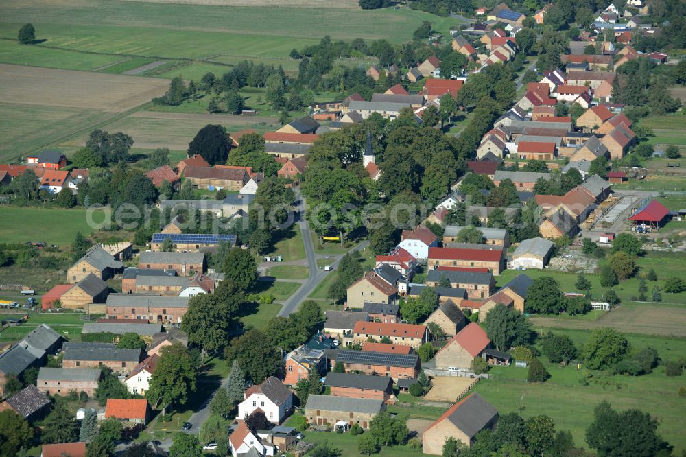 Großmutz from above - Agricultural land and field boundaries surround the settlement area of the village on street Grossmutzer Dorfstrasse in Grossmutz Loewenberger Land in the state Brandenburg, Germany