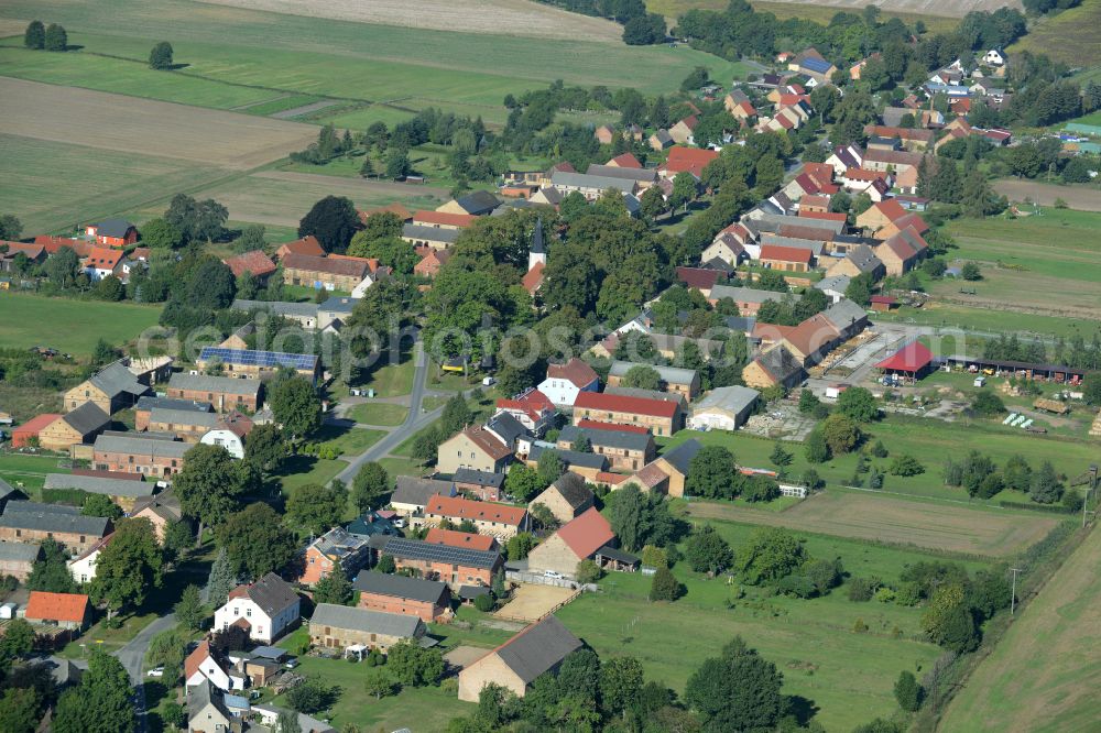 Großmutz from the bird's eye view: Agricultural land and field boundaries surround the settlement area of the village on street Grossmutzer Dorfstrasse in Grossmutz Loewenberger Land in the state Brandenburg, Germany