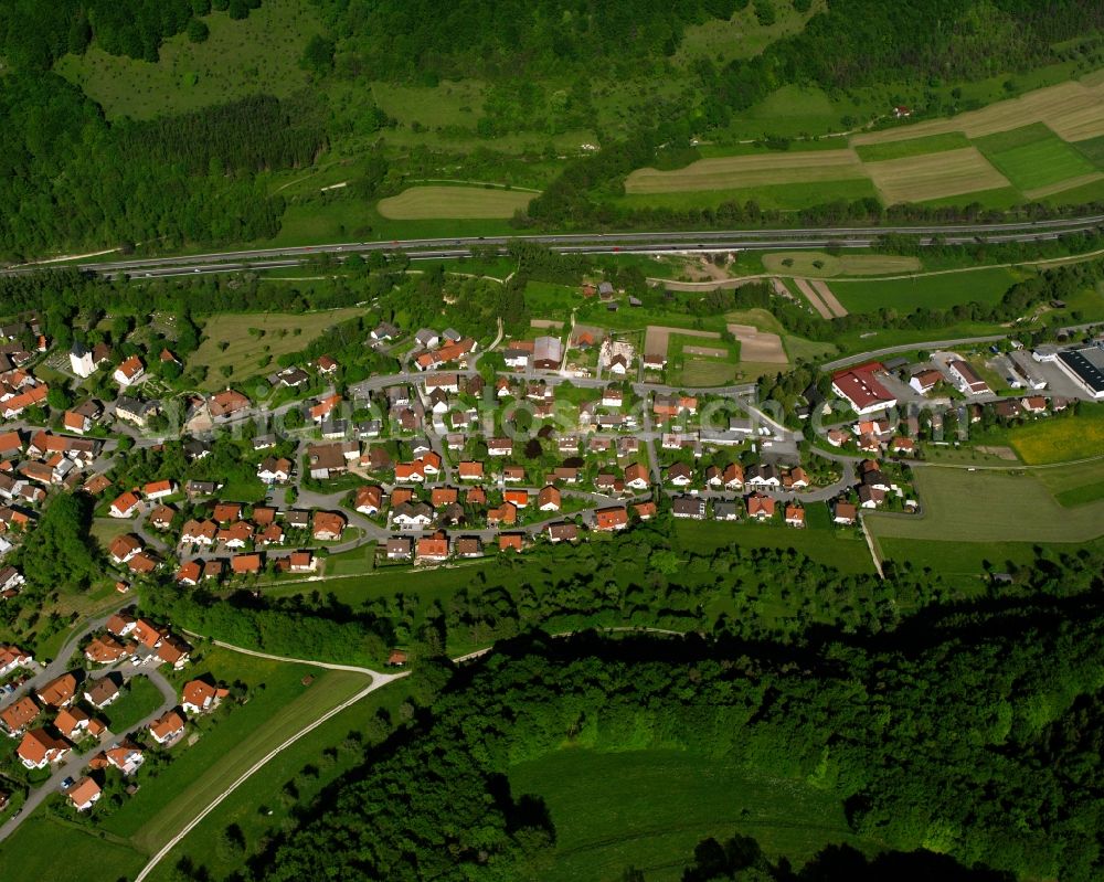 Gruibingen from the bird's eye view: Agricultural land and field boundaries surround the settlement area of the village in Gruibingen in the state Baden-Wuerttemberg, Germany