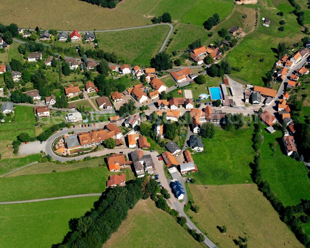 Güttersbach from the bird's eye view: Agricultural land and field boundaries surround the settlement area of the village in Güttersbach in the state Hesse, Germany