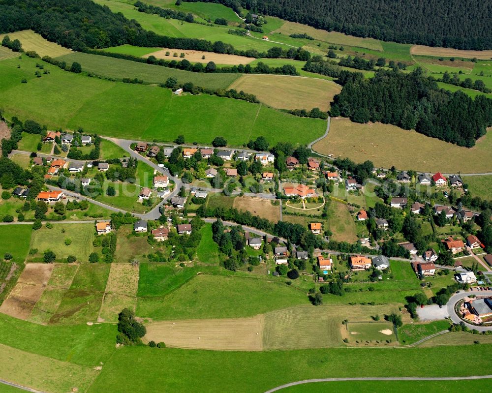 Aerial image Güttersbach - Agricultural land and field boundaries surround the settlement area of the village in Güttersbach in the state Hesse, Germany