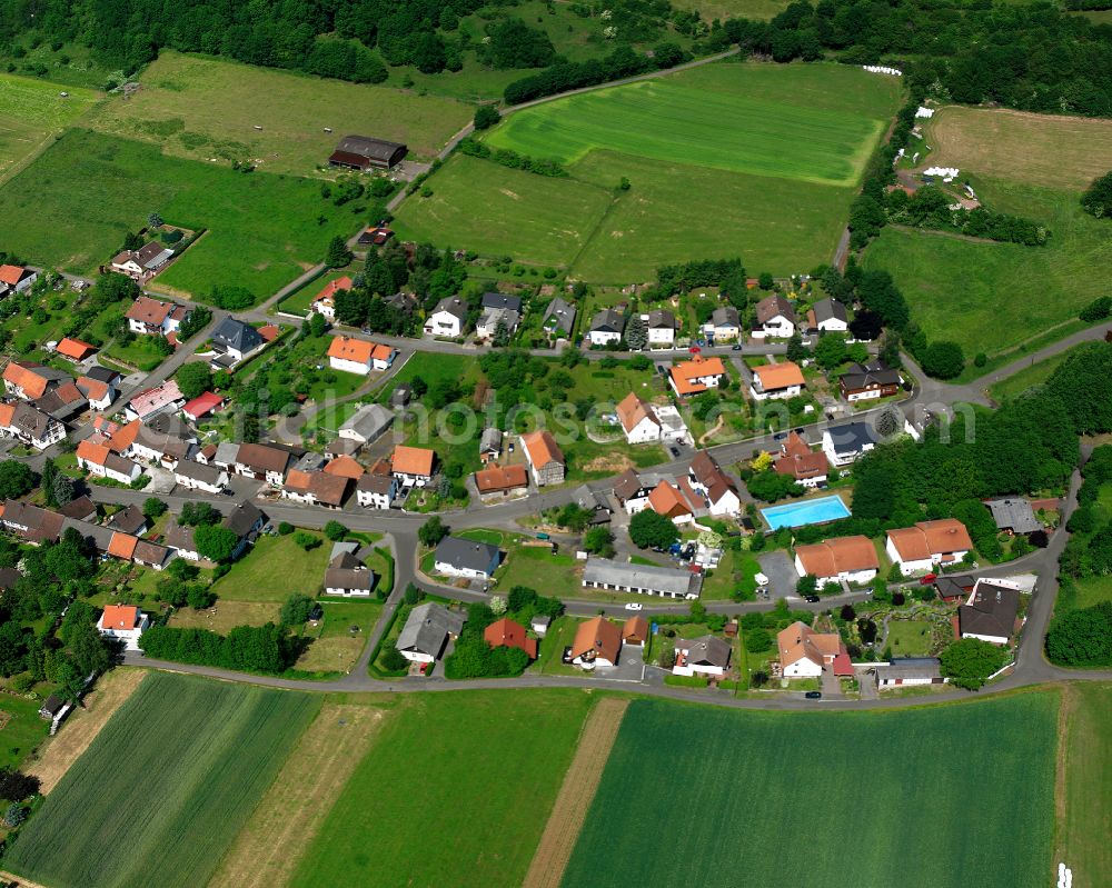 Götzen from the bird's eye view: Agricultural land and field boundaries surround the settlement area of the village in Götzen in the state Hesse, Germany