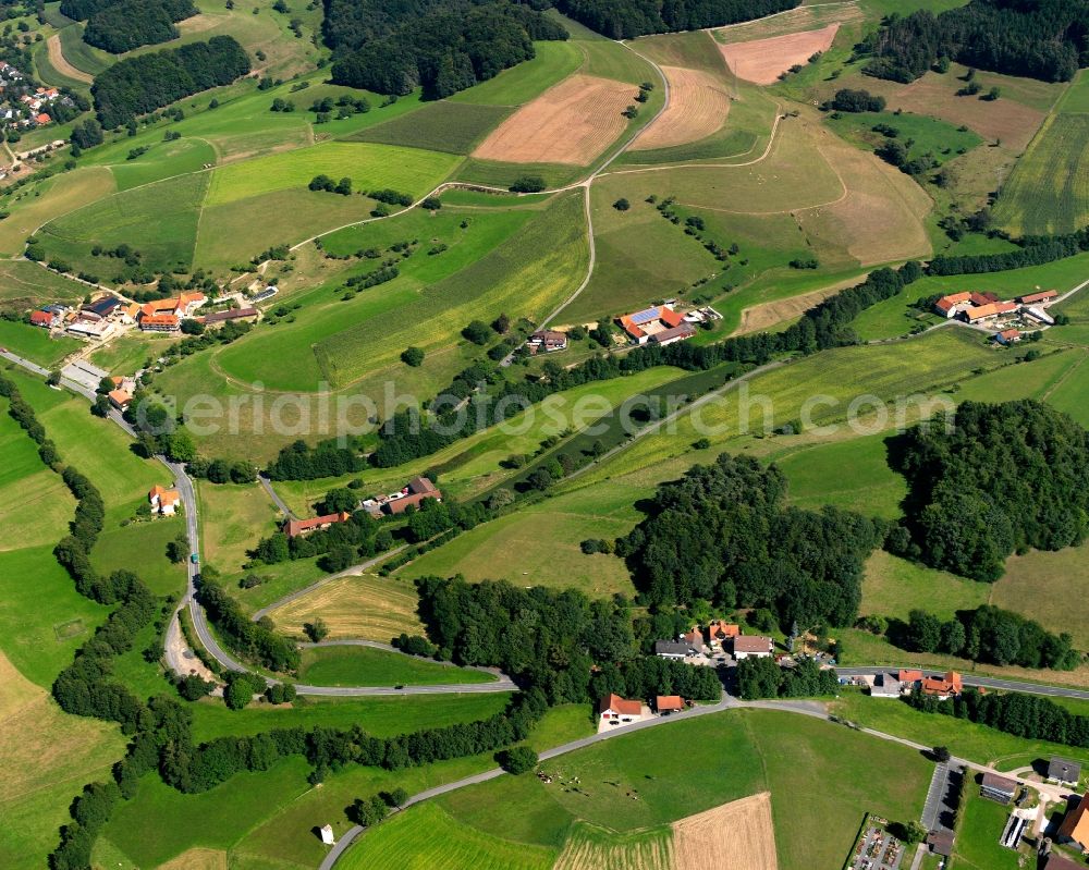 Gumpen from the bird's eye view: Agricultural land and field boundaries surround the settlement area of the village in Gumpen in the state Hesse, Germany