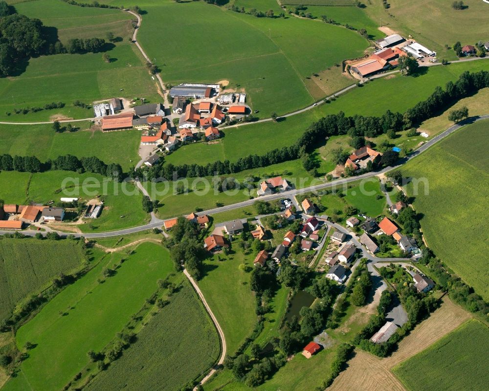 Aerial photograph Gumpen - Agricultural land and field boundaries surround the settlement area of the village in Gumpen in the state Hesse, Germany