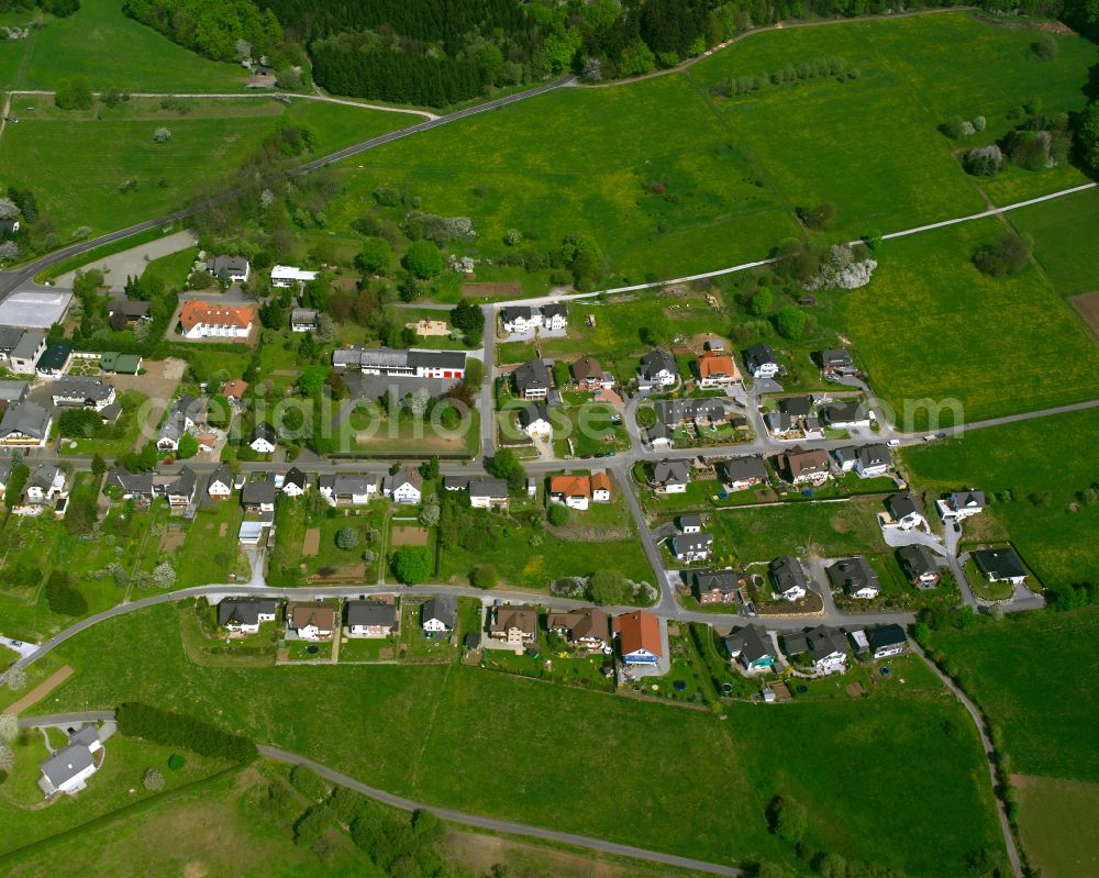 Gusternhain from above - Agricultural land and field boundaries surround the settlement area of the village in Gusternhain in the state Hesse, Germany