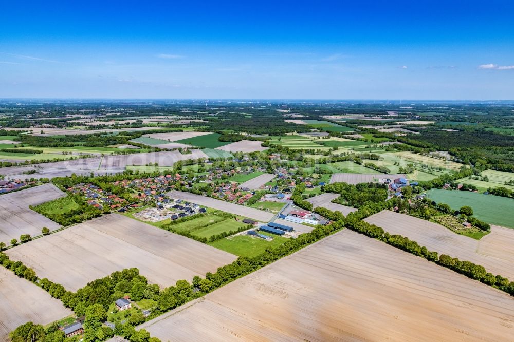 Hagenah from the bird's eye view: Agricultural land and field boundaries surround the settlement area of the village in Hagenah in the state Lower Saxony, Germany