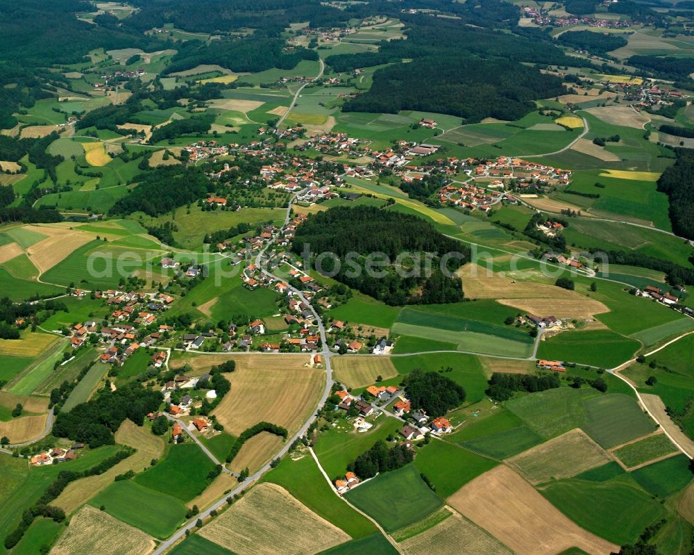 Hagnzell from above - Agricultural land and field boundaries surround the settlement area of the village in Hagnzell in the state Bavaria, Germany