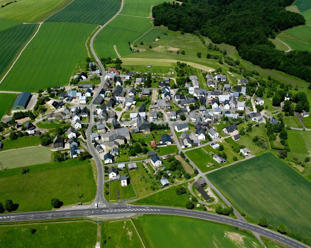 Hahn from above - Agricultural land and field boundaries surround the settlement area of the village in Hahn in the state Rhineland-Palatinate, Germany