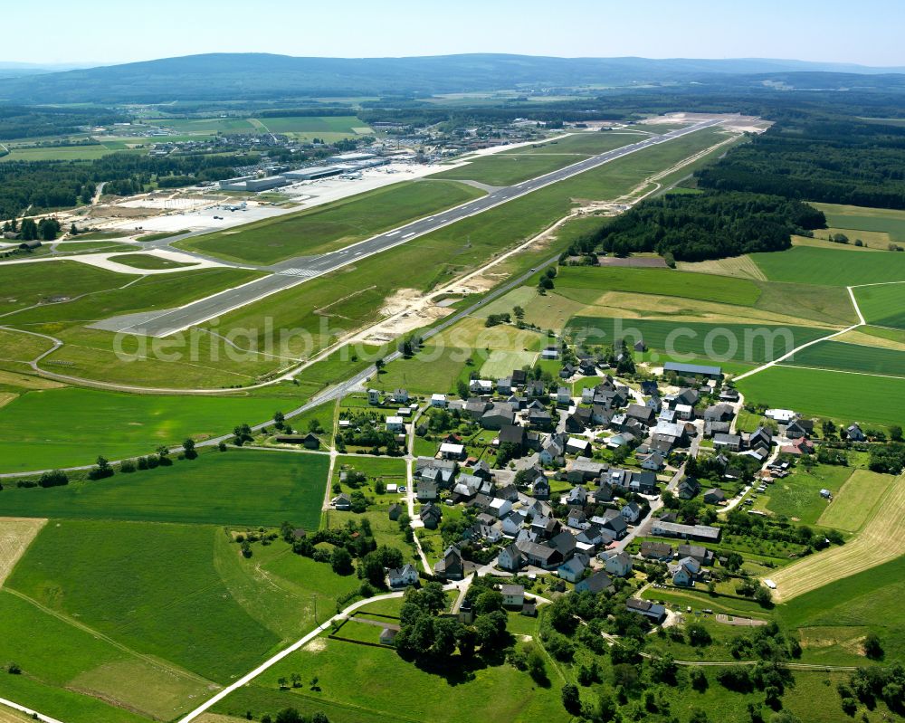 Hahn from the bird's eye view: Agricultural land and field boundaries surround the settlement area of the village in Hahn in the state Rhineland-Palatinate, Germany