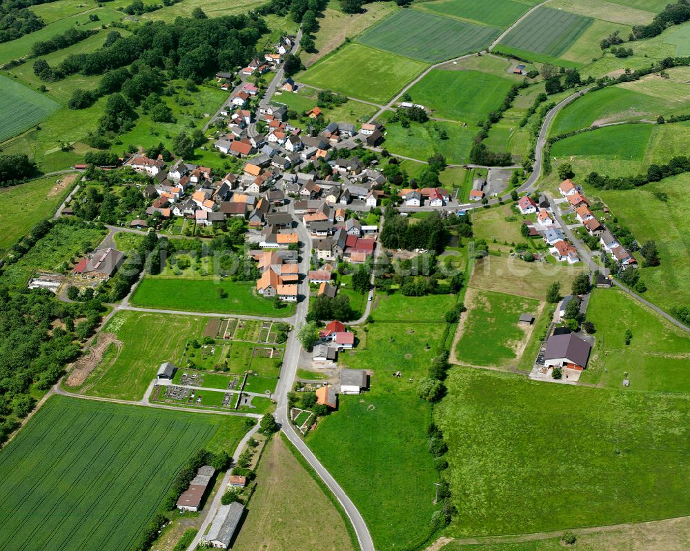 Aerial photograph Hainbach - Agricultural land and field boundaries surround the settlement area of the village in Hainbach in the state Hesse, Germany