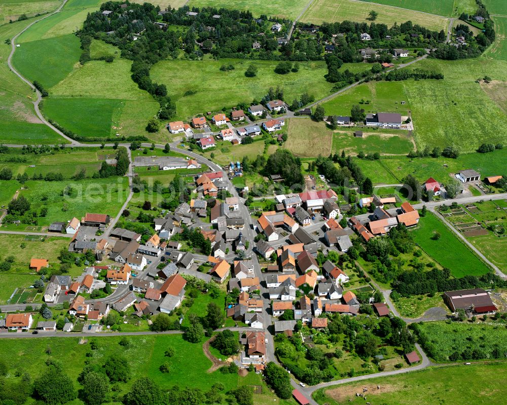 Aerial image Hainbach - Agricultural land and field boundaries surround the settlement area of the village in Hainbach in the state Hesse, Germany