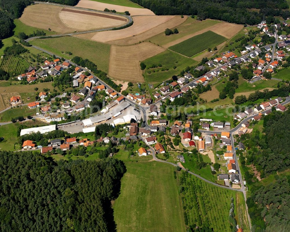 Aerial image Haingrund - Agricultural land and field boundaries surround the settlement area of the village in Haingrund in the state Hesse, Germany