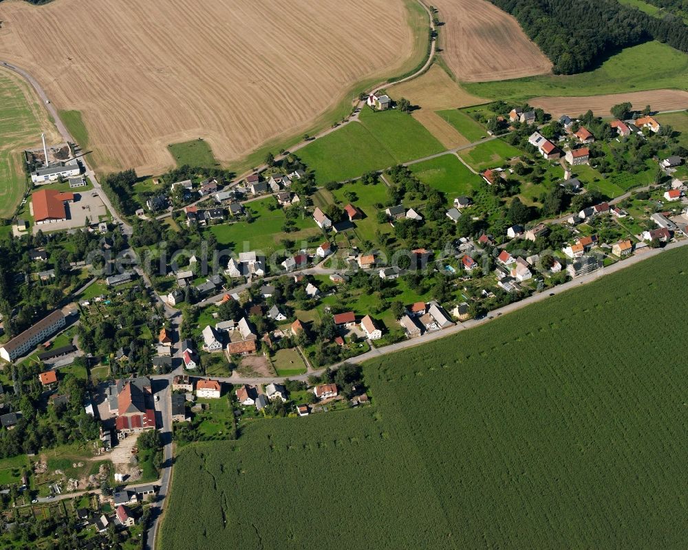 Hainichen from above - Agricultural land and field boundaries surround the settlement area of the village in Hainichen in the state Saxony, Germany