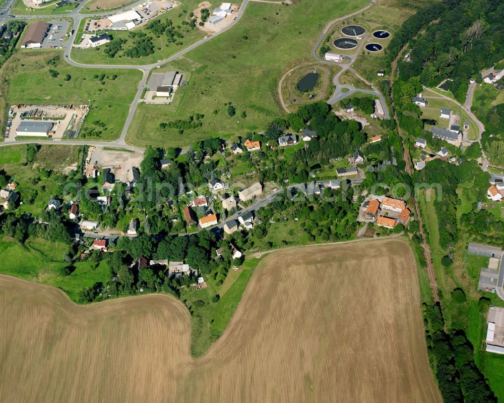 Hainichen from the bird's eye view: Agricultural land and field boundaries surround the settlement area of the village in Hainichen in the state Saxony, Germany