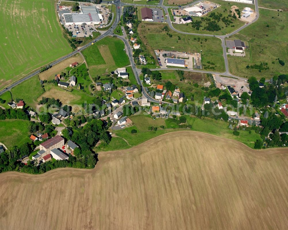 Aerial image Hainichen - Agricultural land and field boundaries surround the settlement area of the village in Hainichen in the state Saxony, Germany