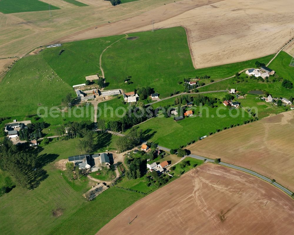 Aerial image Hainichen - Agricultural land and field boundaries surround the settlement area of the village in Hainichen in the state Saxony, Germany