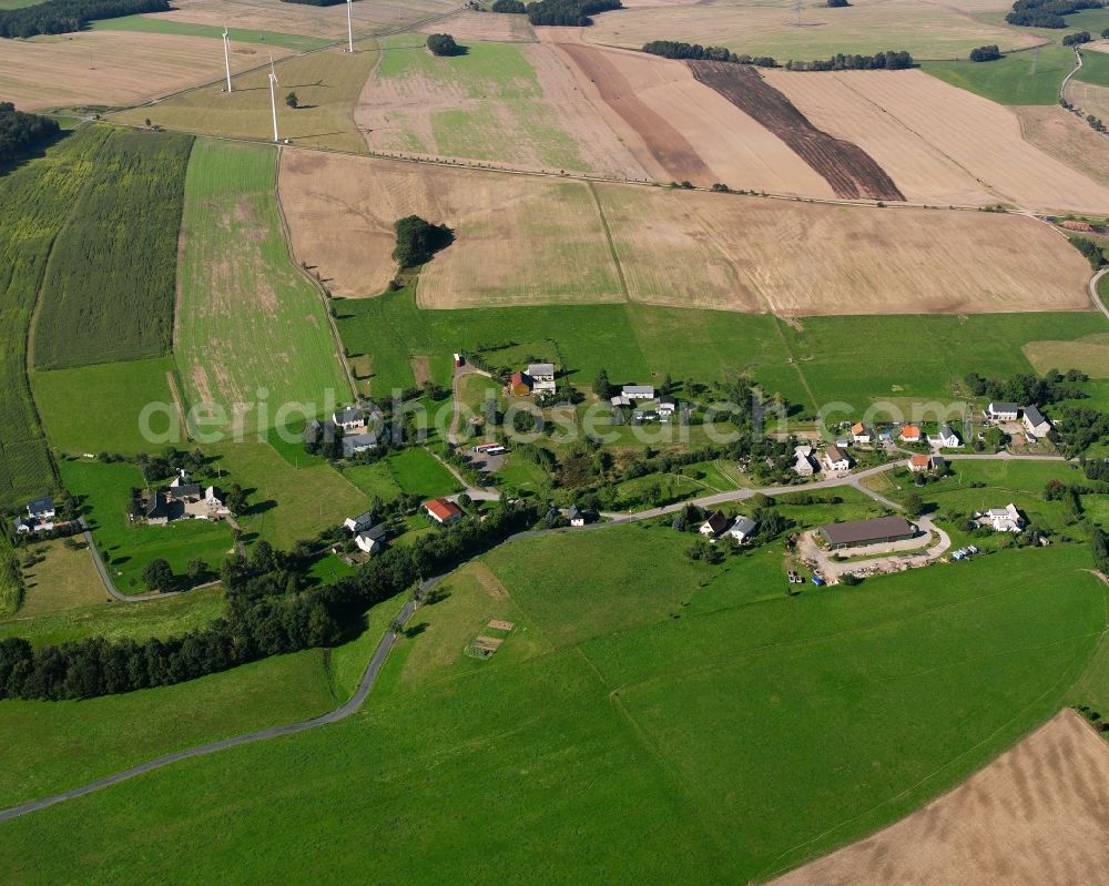 Hainichen from above - Agricultural land and field boundaries surround the settlement area of the village in Hainichen in the state Saxony, Germany