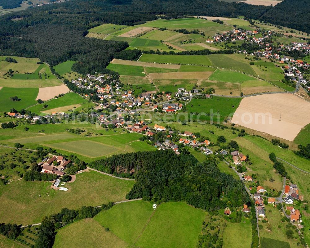 Haisterbach from above - Agricultural land and field boundaries surround the settlement area of the village in Haisterbach in the state Hesse, Germany