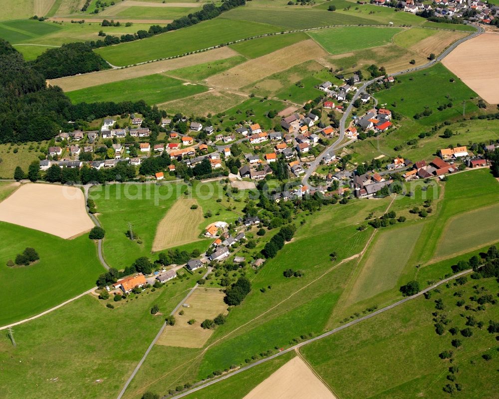 Haisterbach from the bird's eye view: Agricultural land and field boundaries surround the settlement area of the village in Haisterbach in the state Hesse, Germany