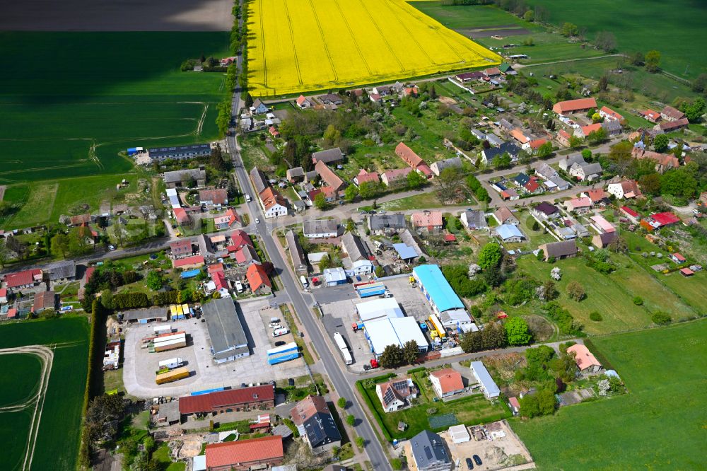 Hakenberg from above - Agricultural land and field boundaries surround the settlement area of the village in Hakenberg in the state Brandenburg, Germany