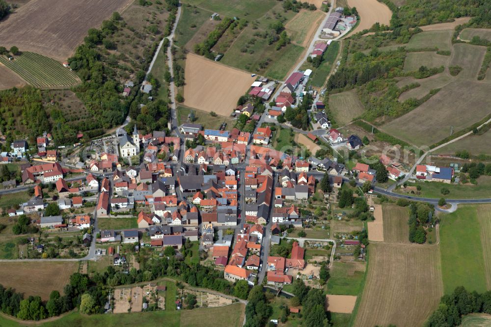 Halsheim from above - Agricultural land and field boundaries surround the settlement area of the village in Halsheim in the state Bavaria, Germany