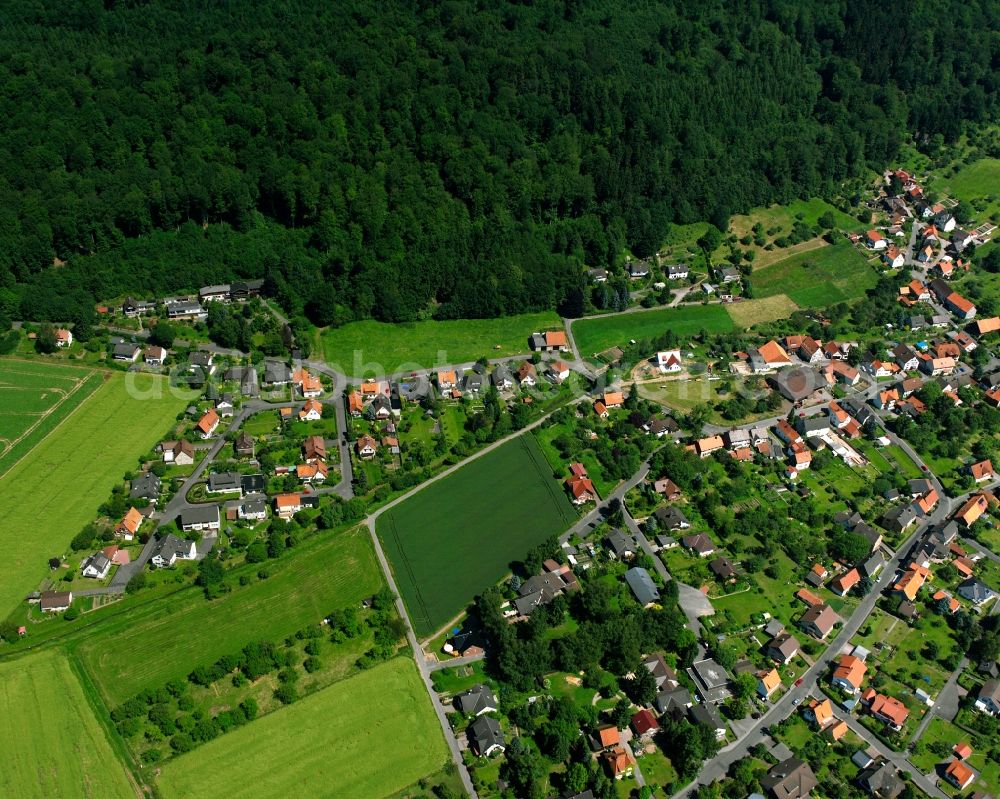 Aerial image Hann. Münden - Agricultural land and field boundaries surround the settlement area of the village in Hann. Muenden in the state Lower Saxony, Germany