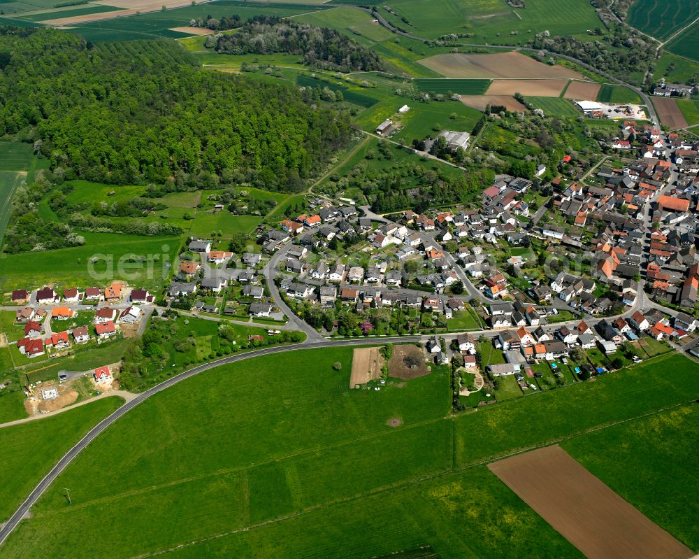 Harbach from above - Agricultural land and field boundaries surround the settlement area of the village in Harbach in the state Hesse, Germany