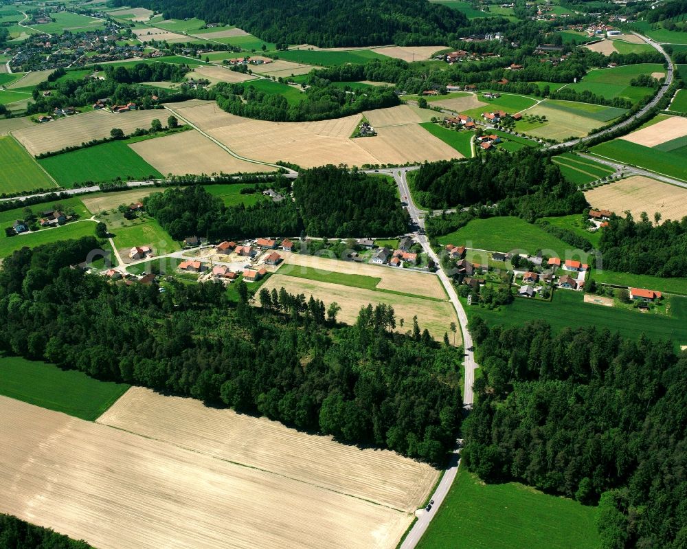 Hart from the bird's eye view: Agricultural land and field boundaries surround the settlement area of the village in Hart in the state Bavaria, Germany