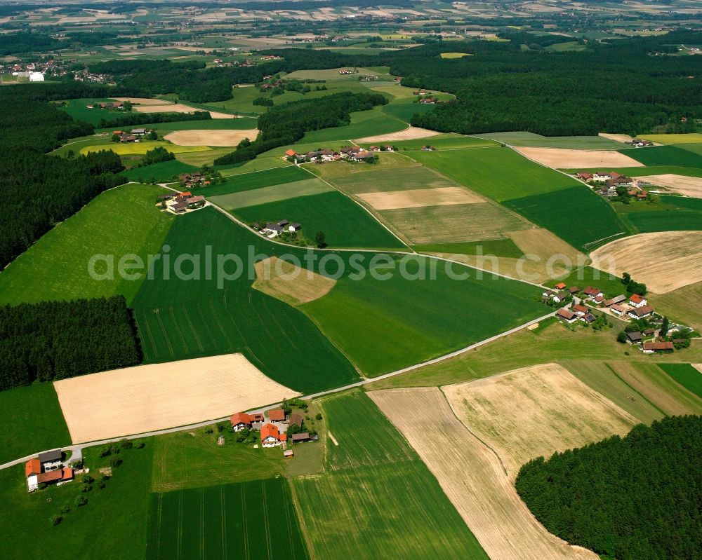 Haselbach from above - Agricultural land and field boundaries surround the settlement area of the village in Haselbach in the state Bavaria, Germany